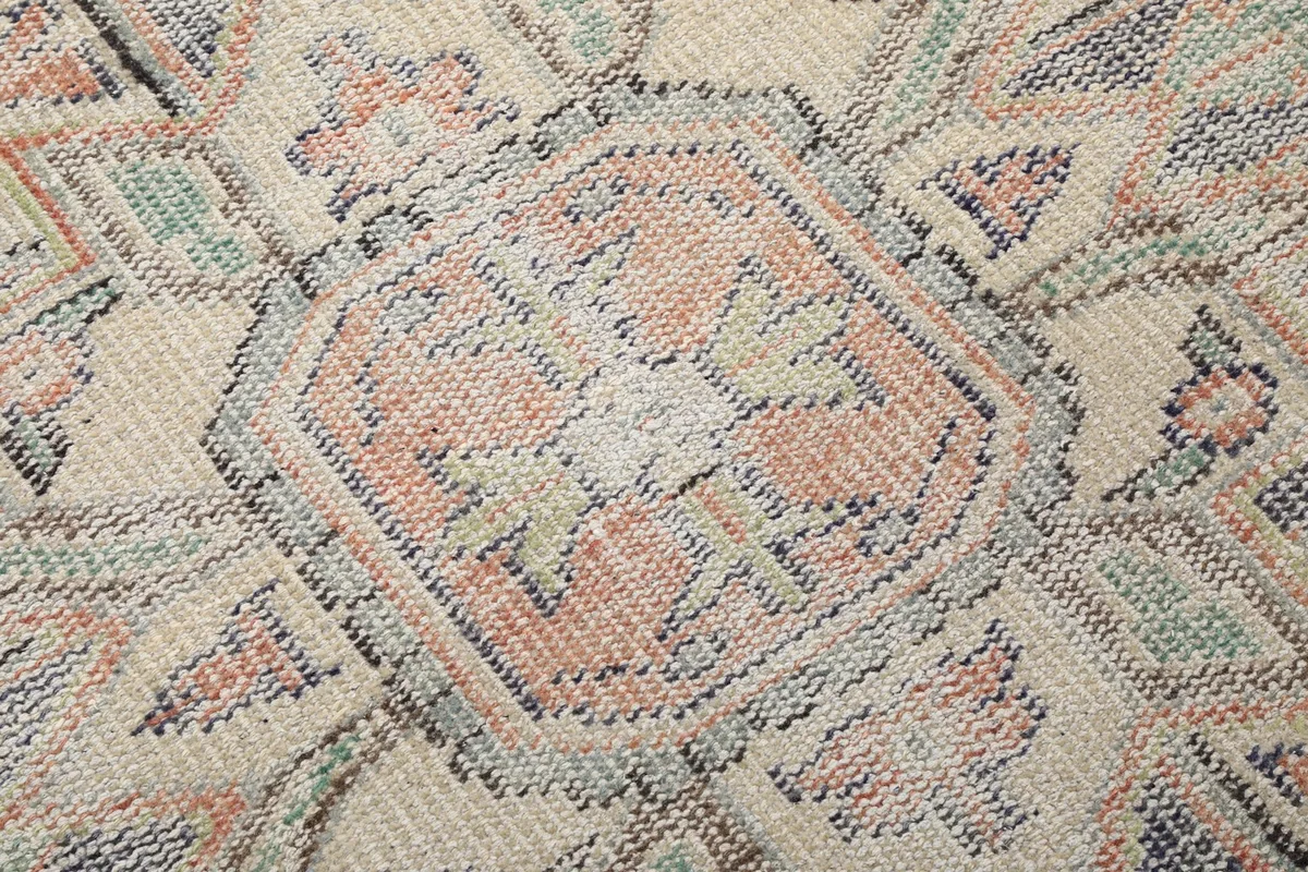 Extreme close-up of the hand-knotted wool pile, revealing texture and subtle color variations