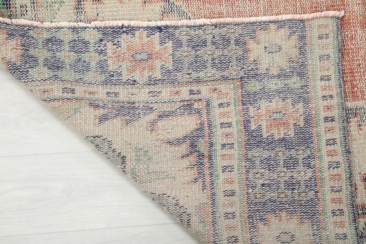 Underside of the rug, revealing the woven cotton foundation and knotting structure