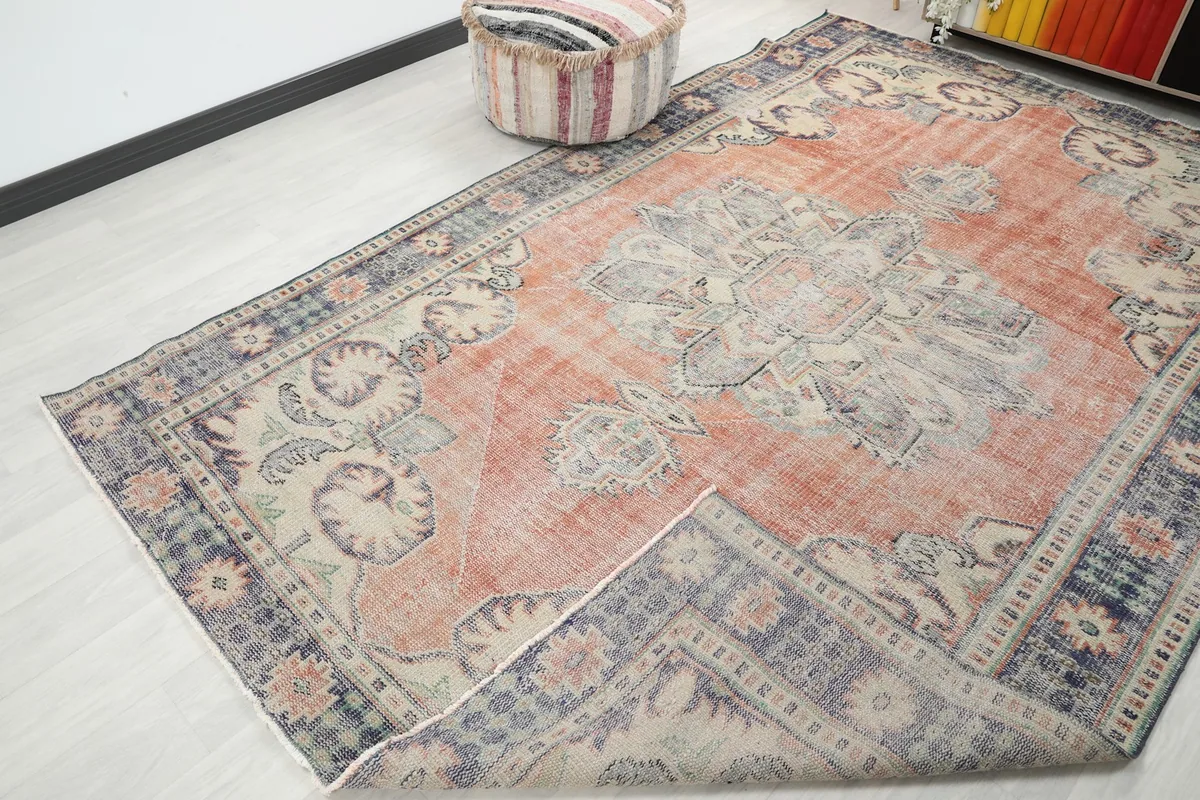 Rug partially folded, showing the full design and flexibility of the vintage hand-knotted wool