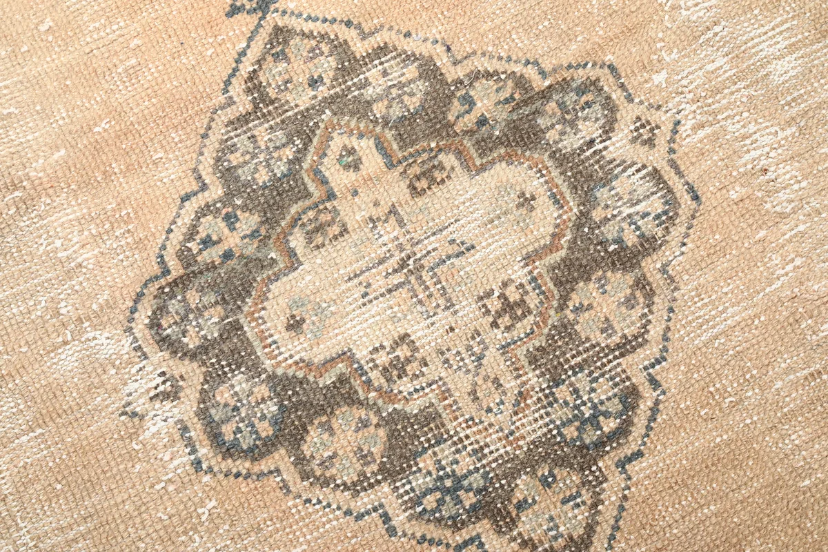 Close-up of the distressed wool pile and intricate medallion design