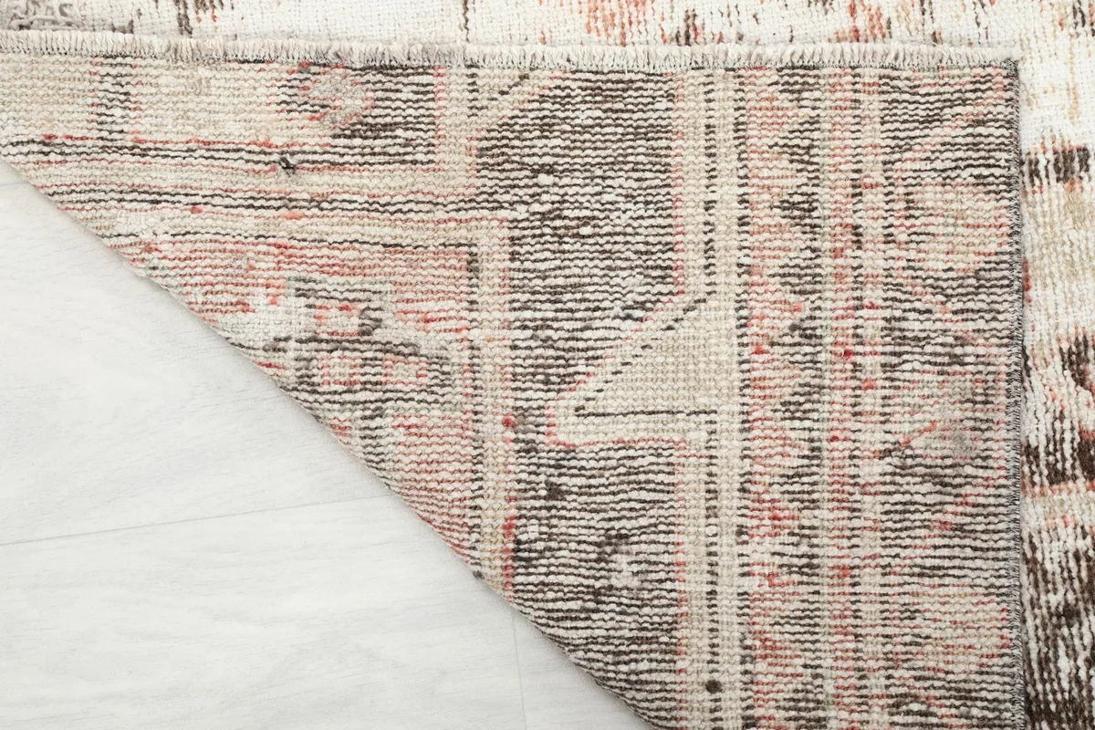 Close-up of the back of the rug, illustrating the tight hand-knotted wool on cotton foundation.