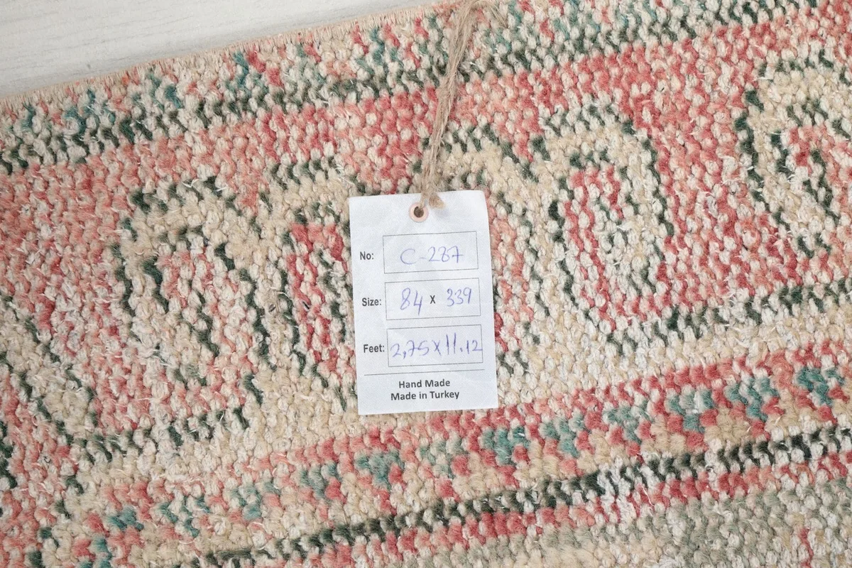 Close-up of the product tag attached to the rug, displaying its size and origin information.