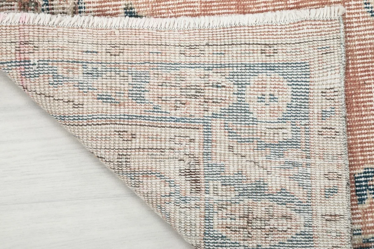 Close-up of the rug's reverse side, showing the hand-knotted cotton foundation