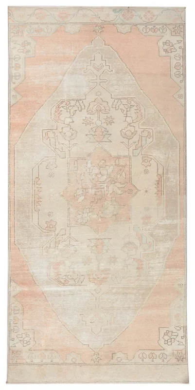 Top view of a hand-knotted vintage Anatolian rug with an orange field and ivory medallion