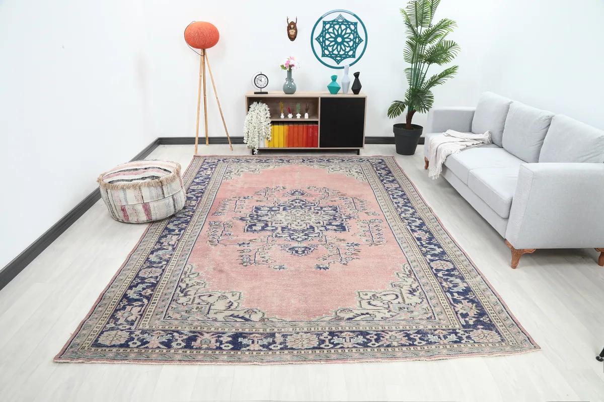 Rose Navy Medallion Anatolian Rug in a living room setting, viewed from an angle.