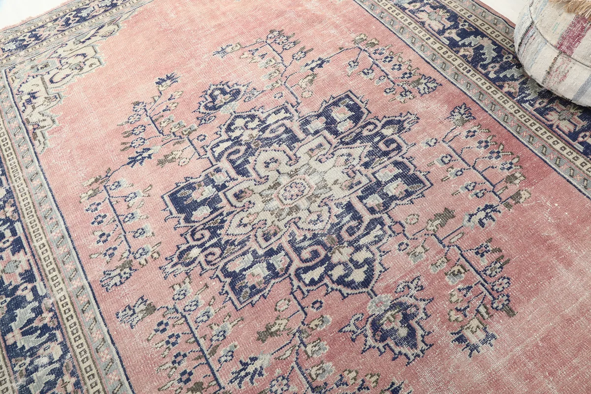 Close-up of the central medallion and surrounding floral motifs on the Rose Navy Medallian Anatolian Rug.