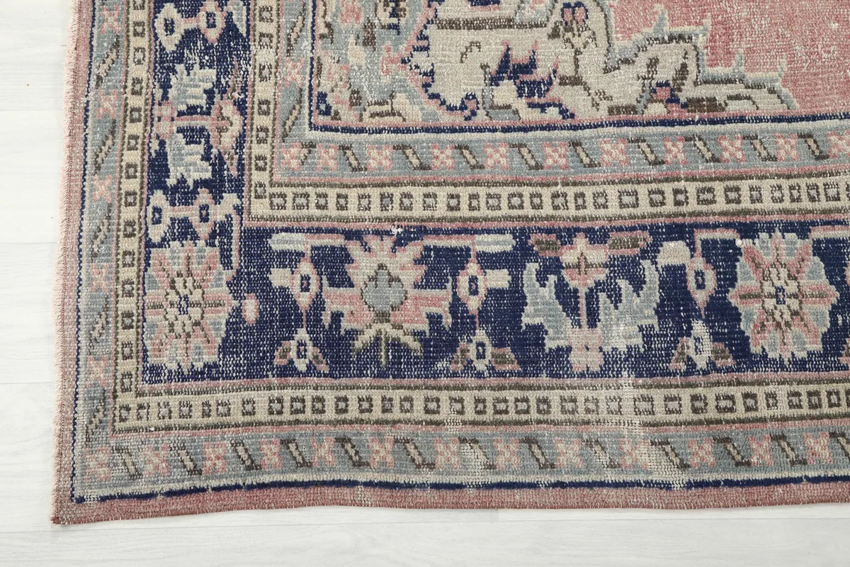 Corner detail of the Rose Navy Medallion Anatolian Rug, showing the layered border design.