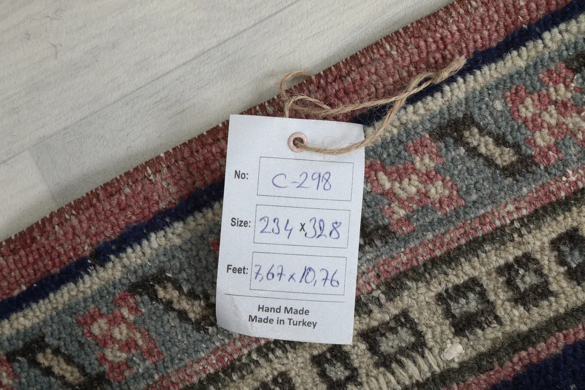 Product tag attached to the Rose Navy Medallion Anatolian Rug, displaying size and origin.