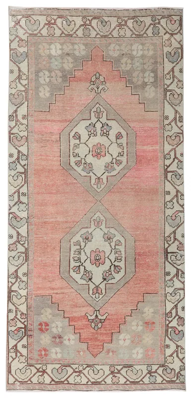 Full overhead view of the rose and gray vintage Anatolian wool runner with geometric floral motifs.