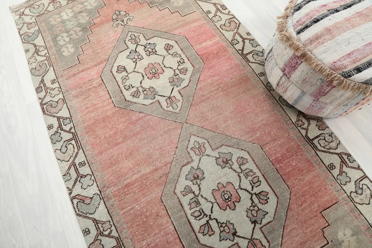 Diagonal view of the runner's full length, emphasizing the rose and gray color palette and motifs.