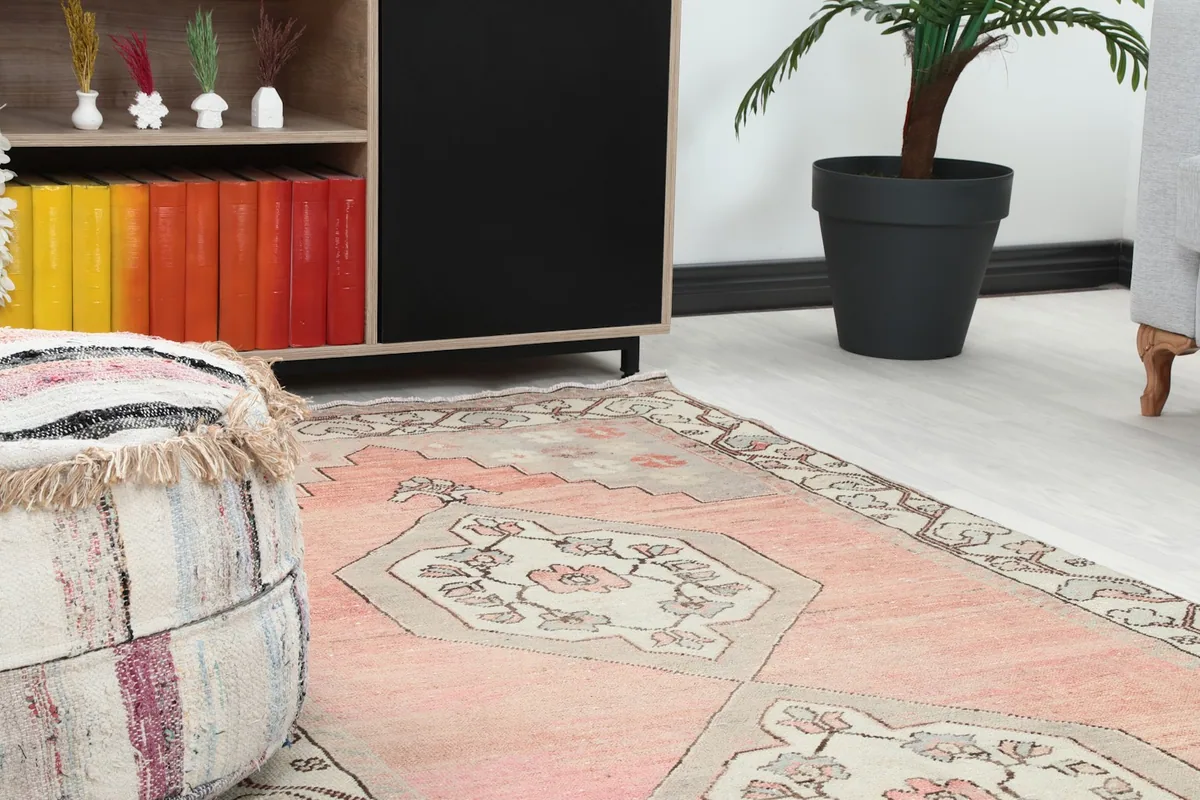 Close-up view of the runner's pattern and colors in a room setting, next to a textured ottoman.