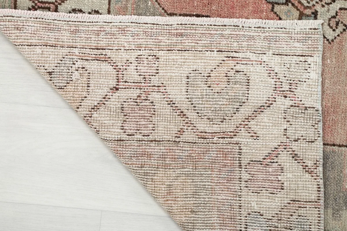 Close-up of the back of the rug, illustrating the tight hand-knotted wool pile on cotton foundation.