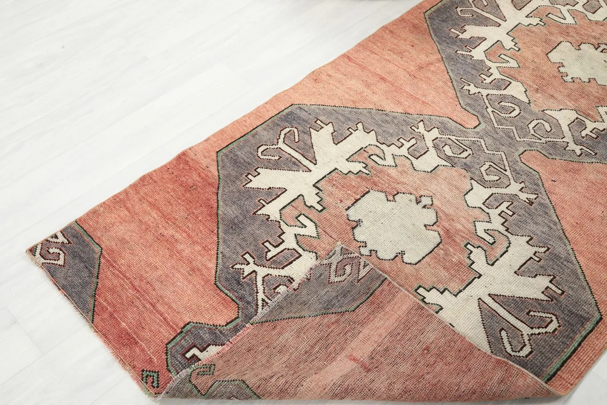 Corner of the runner rug folded back, showcasing the flexibility and construction of the piece