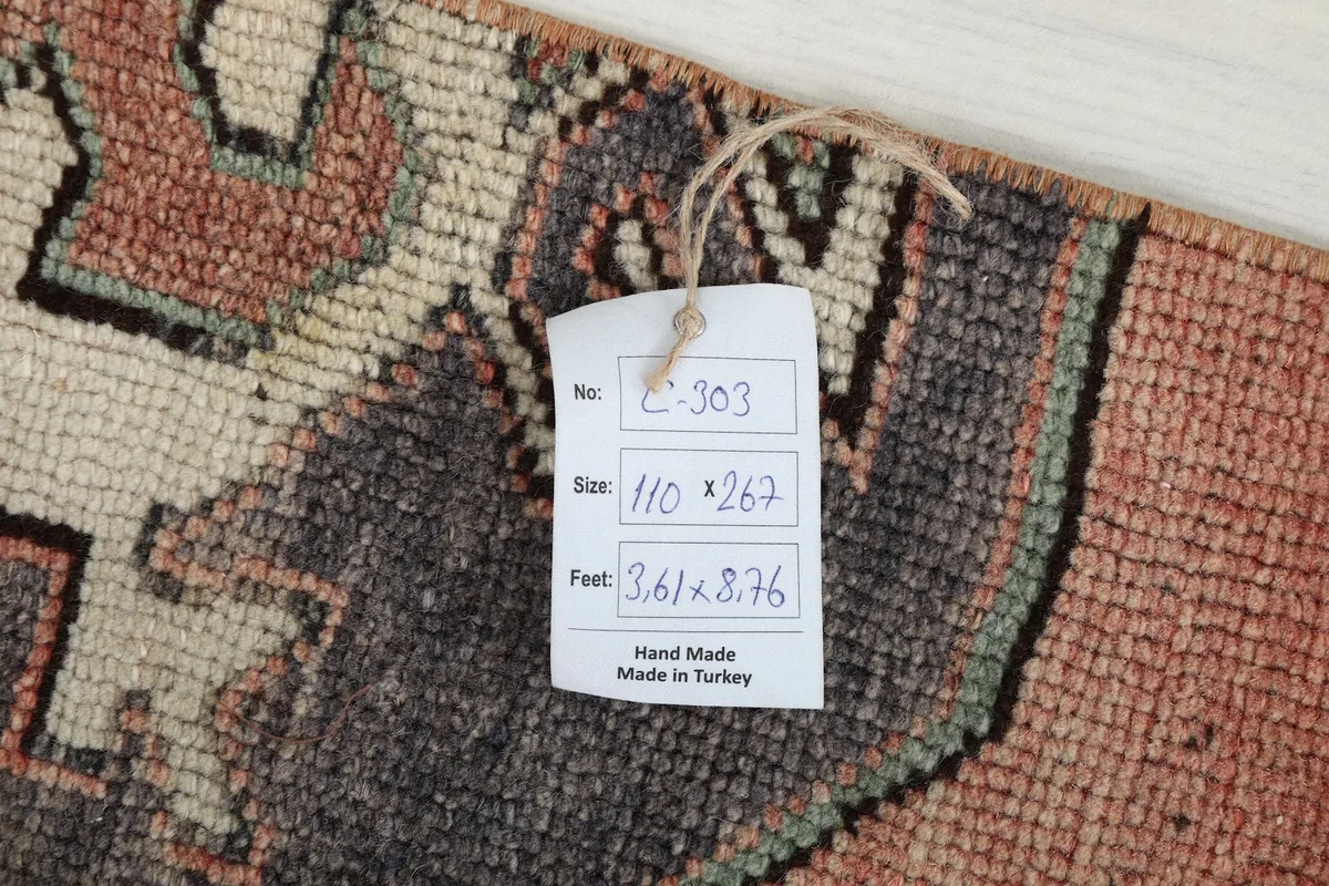 Tag with rug details, including size in centimeters and feet, confirming hand-made origin in Turkey