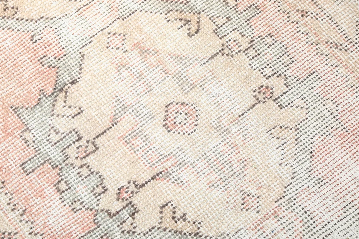 Close-up showing the low pile and intricate hand-knotted wool texture