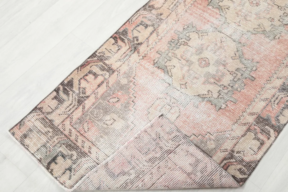 Folded corner of the runner rug, showing the reverse side and construction