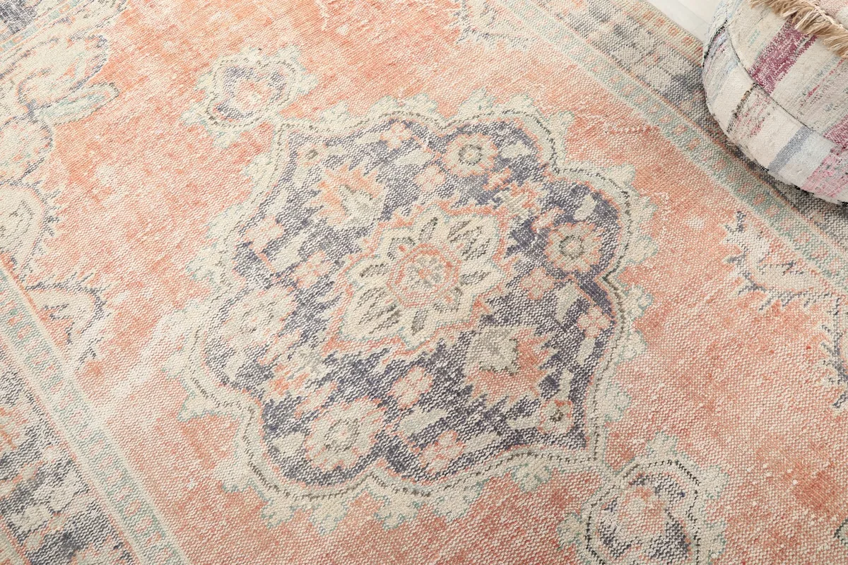 Detailed close-up of the central blue medallion with orange and beige accents