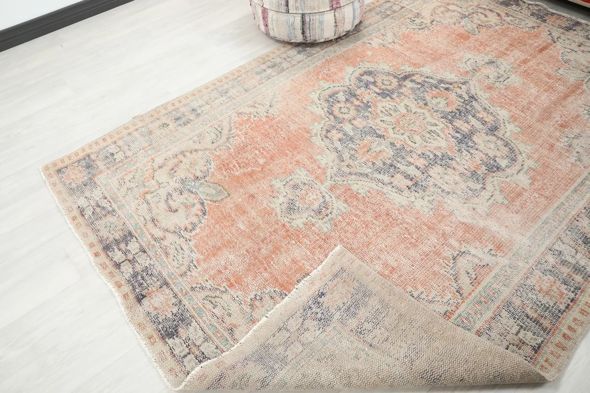 Rug corner folded back to show the underside and fringe, demonstrating flexibility