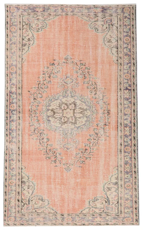 Full overhead view of the orange vintage Anatolian rug with a central medallion on a white background