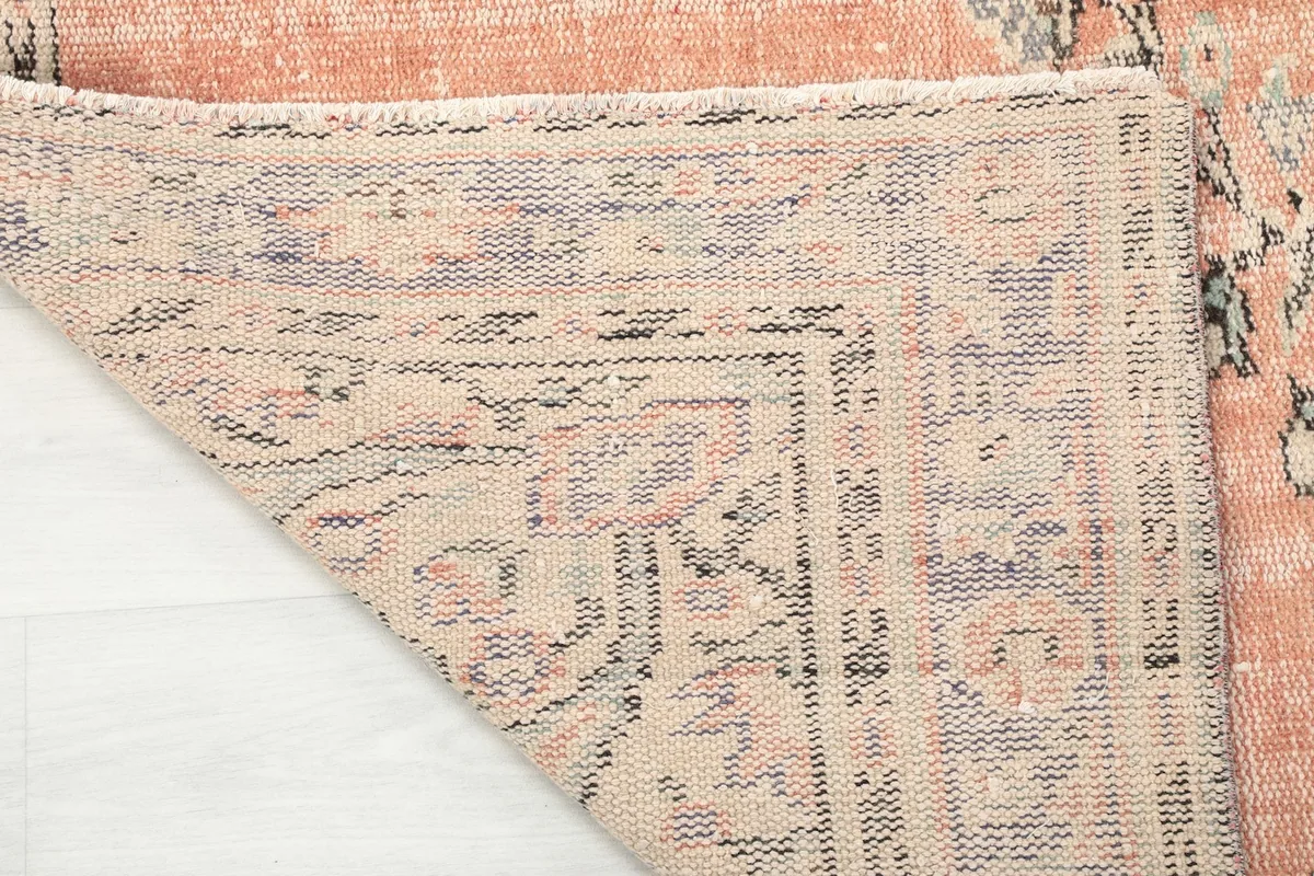 Close-up of the back of the hand-knotted rug, showing the cotton foundation and knotting detail