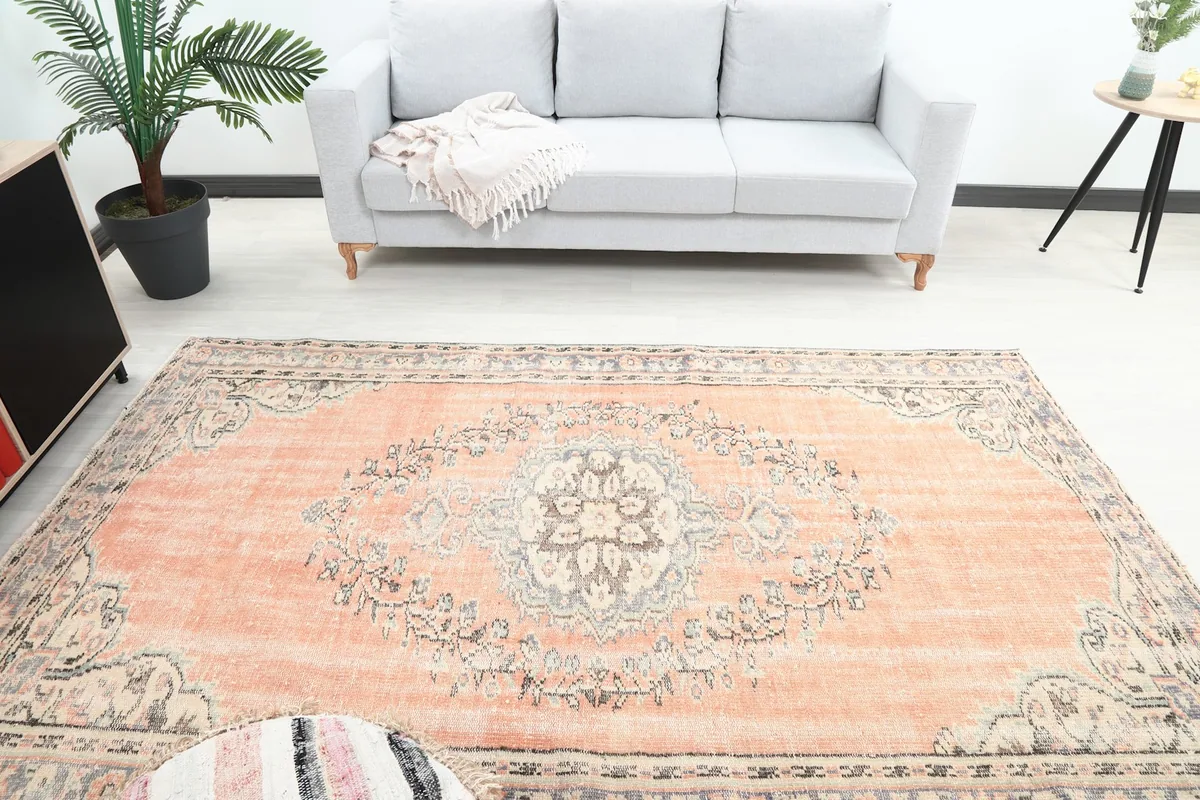 Overhead view of the orange rug in a room, highlighting the central medallion and overall pattern