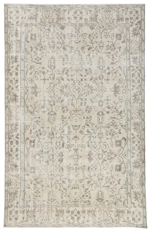 Full top view of the beige and gray vintage Anatolian area rug, showcasing its floral and geometric patterns.
