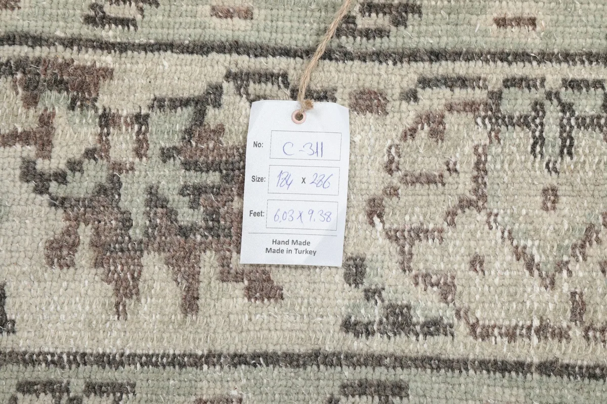 Close-up of the product tag attached to the rug, showing details like size and origin.