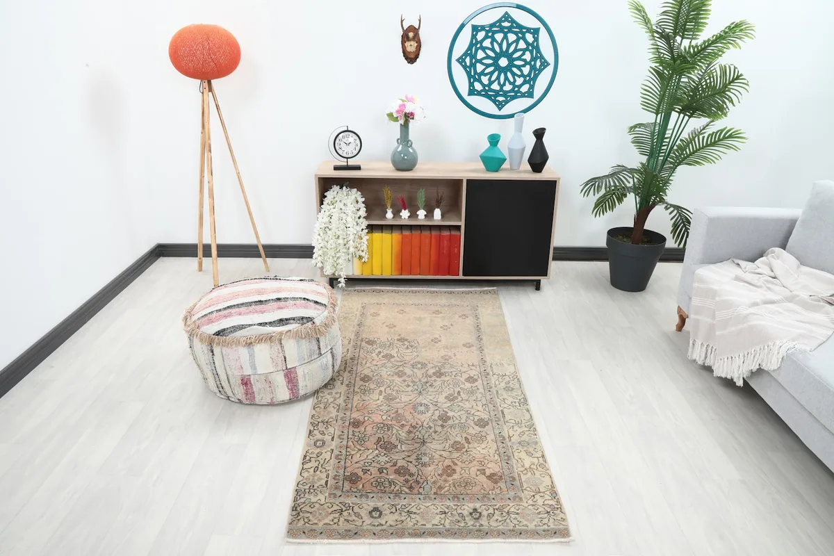 Vintage Anatolian rug placed in a modern living room setting, viewed from an angle.