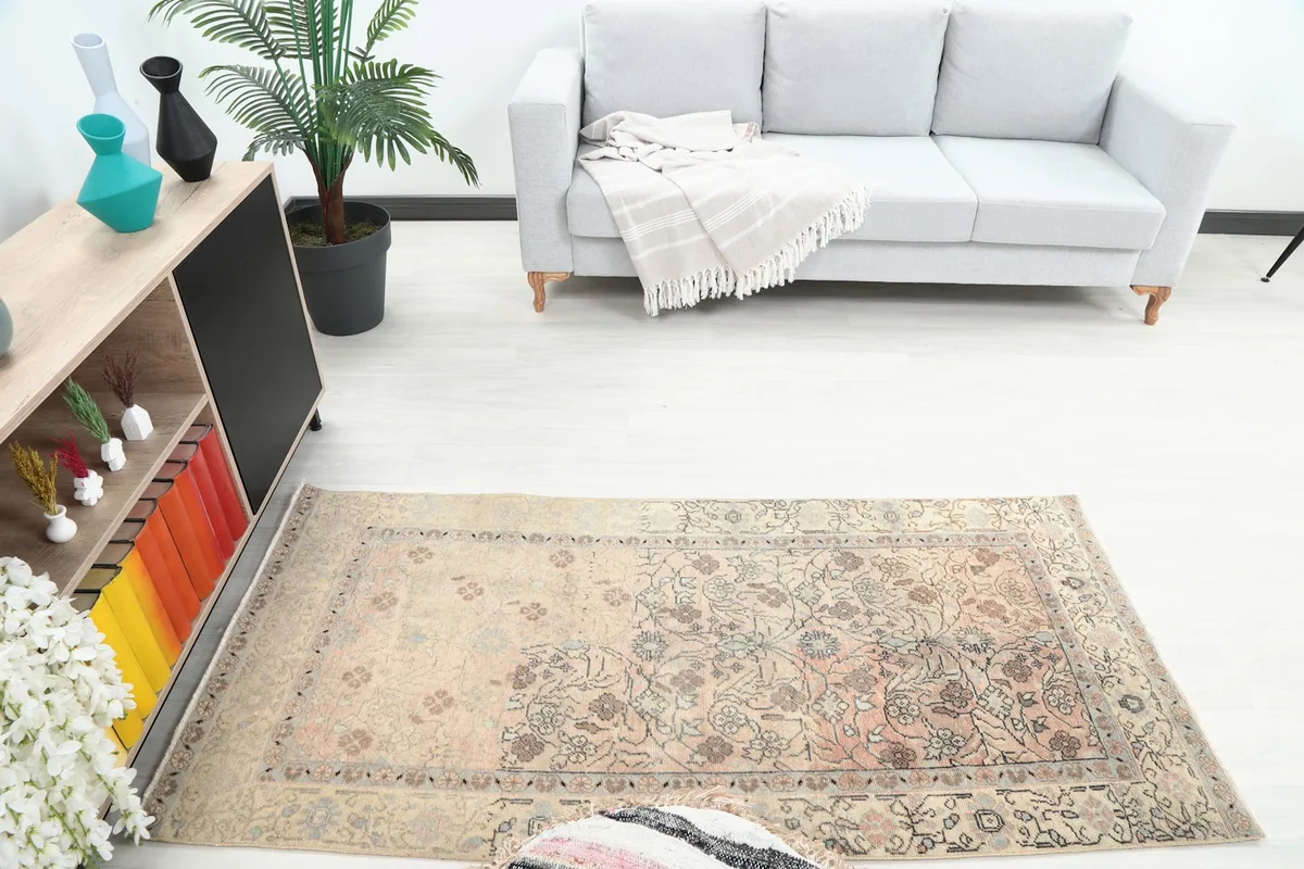 Overhead view of the small area rug in a room, showing its placement relative to furniture.