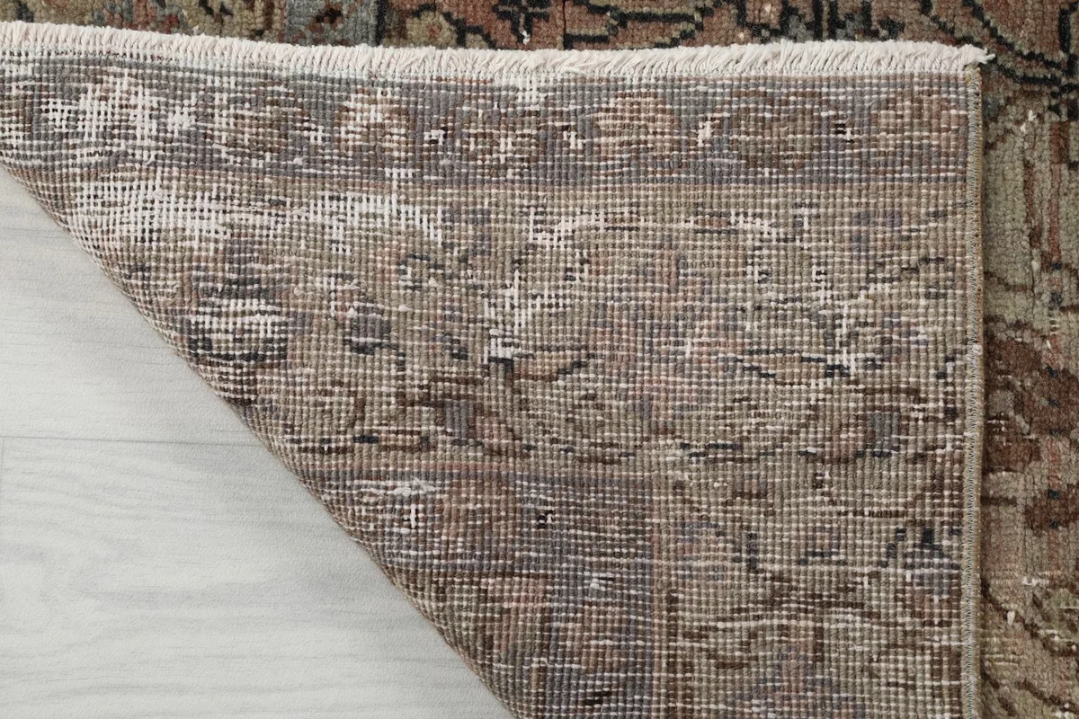 Close-up of the rug's cotton foundation and the back of the hand-knotted wool pile.