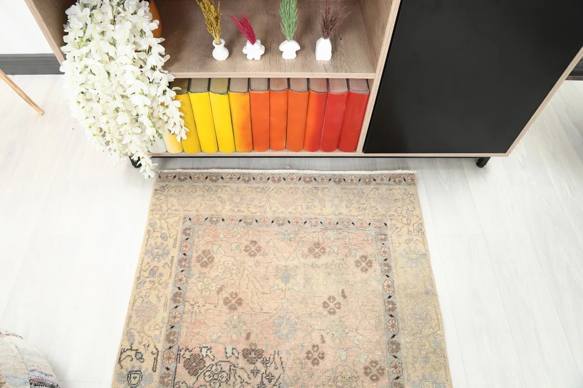 Direct overhead shot of the rug, highlighting its rose field and ivory border design.