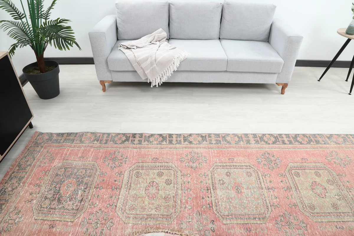 Overhead view of the Faded Rose Geometric Anatolian Runner's central design and border patterns.