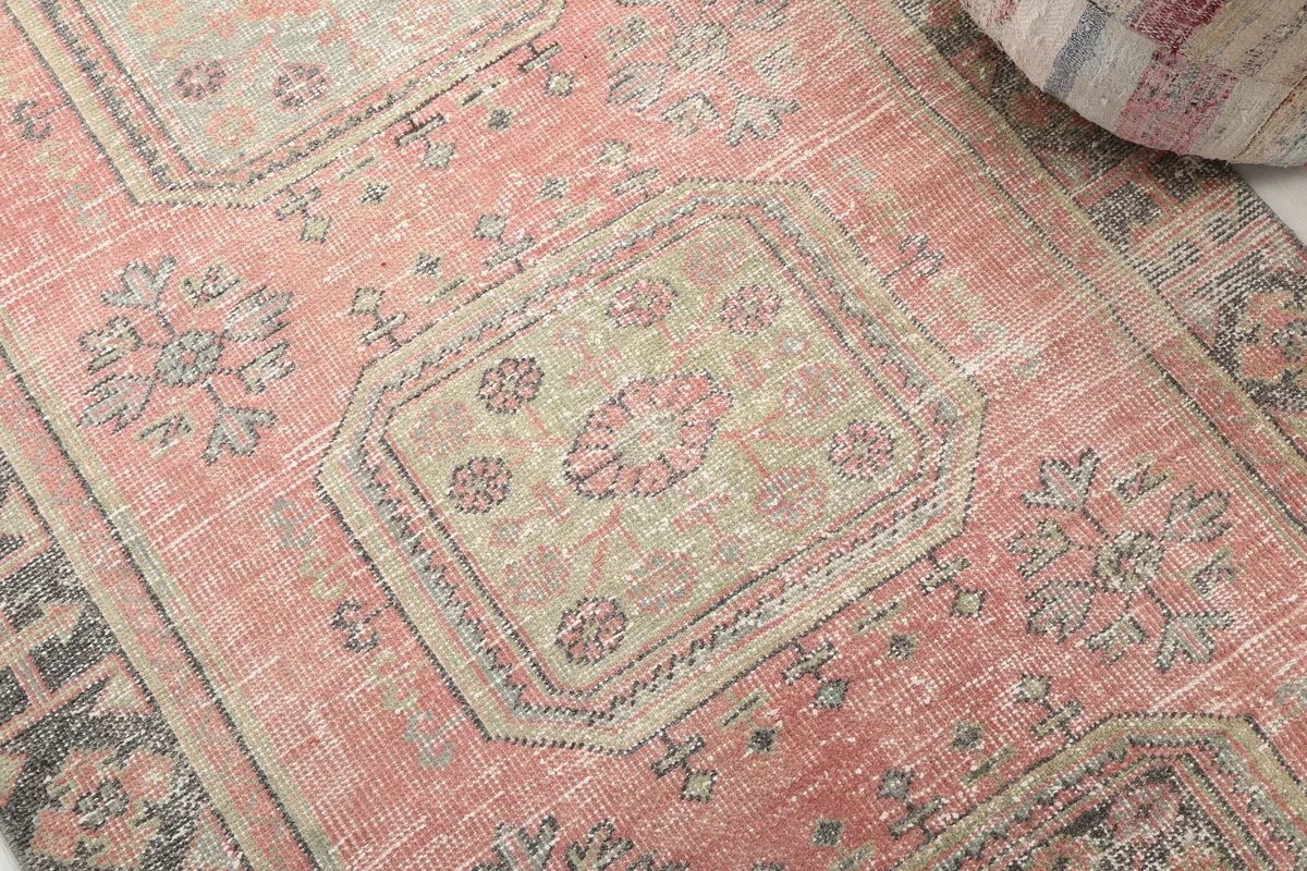 Close-up of a geometric medallion on the Faded Rose Geometric Anatolian Runner, showing olive and beige tones.