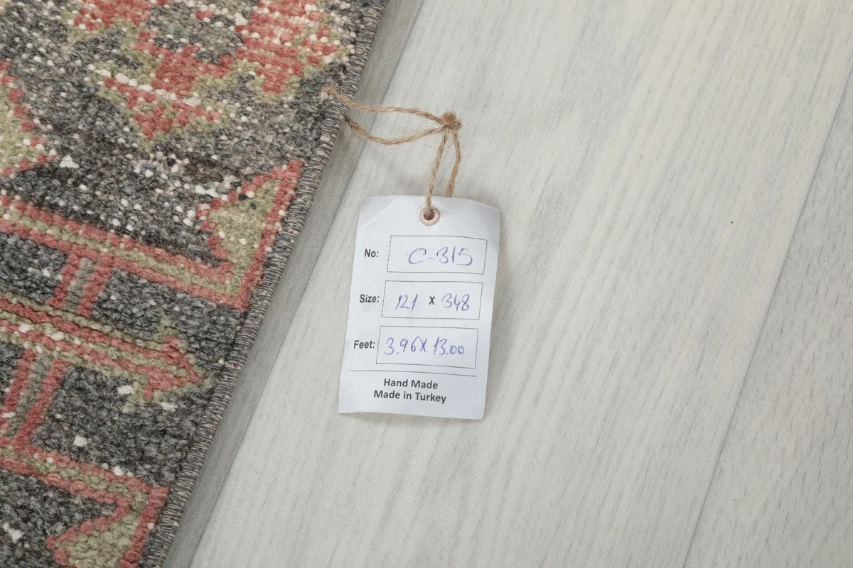 Tag showing the dimensions of the Faded Rose Geometric Anatolian Runner in centimeters and feet.