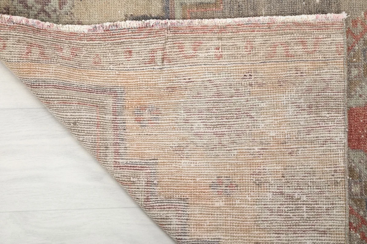 Close-up of the back of the hand-knotted rug, illustrating the dense cotton foundation and knotting craftsmanship.
