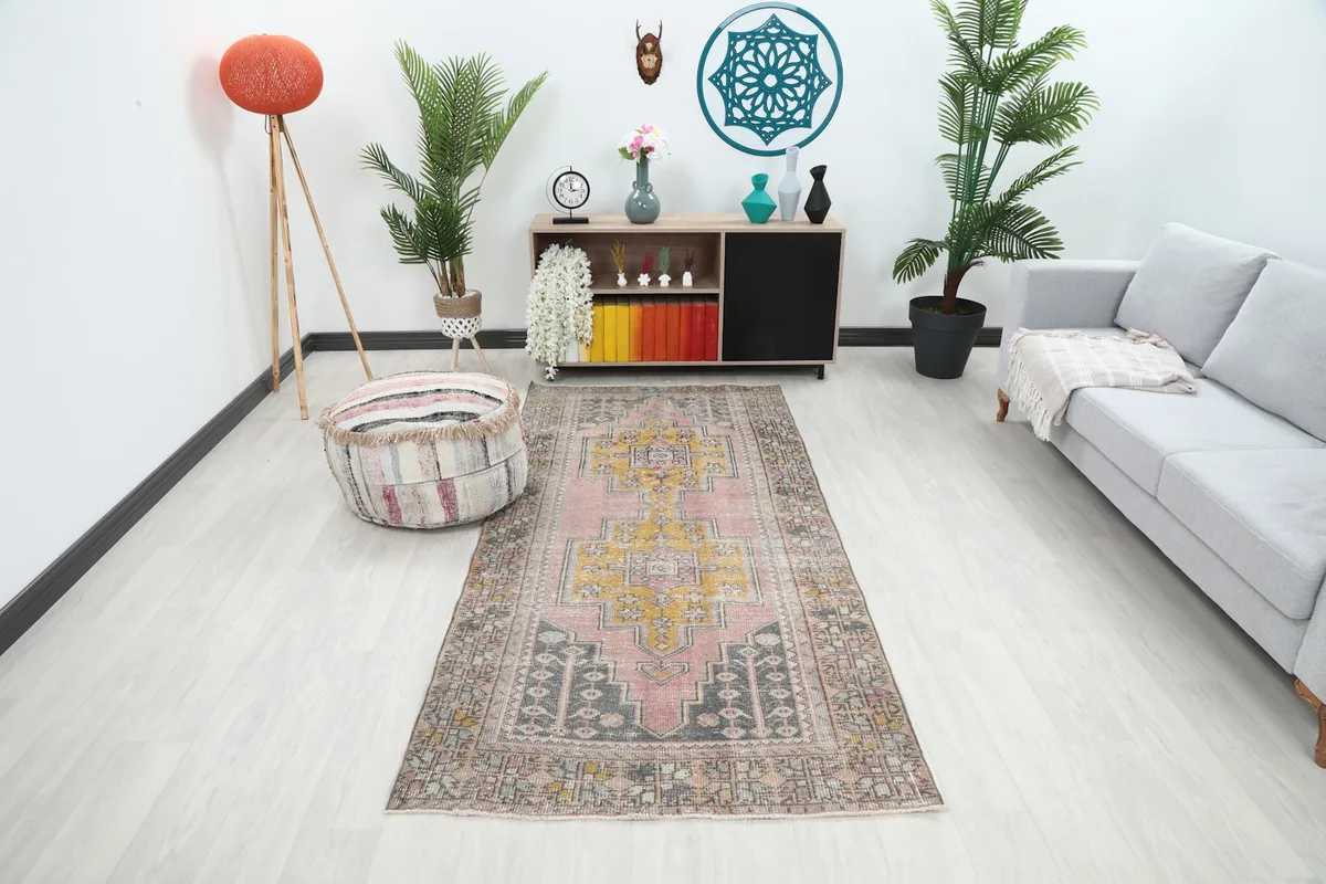 Vintage pink runner in a living room setting, showing its scale and color