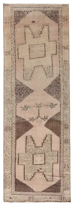 Full top view of a beige and brown geometric vintage runner rug on a white background.