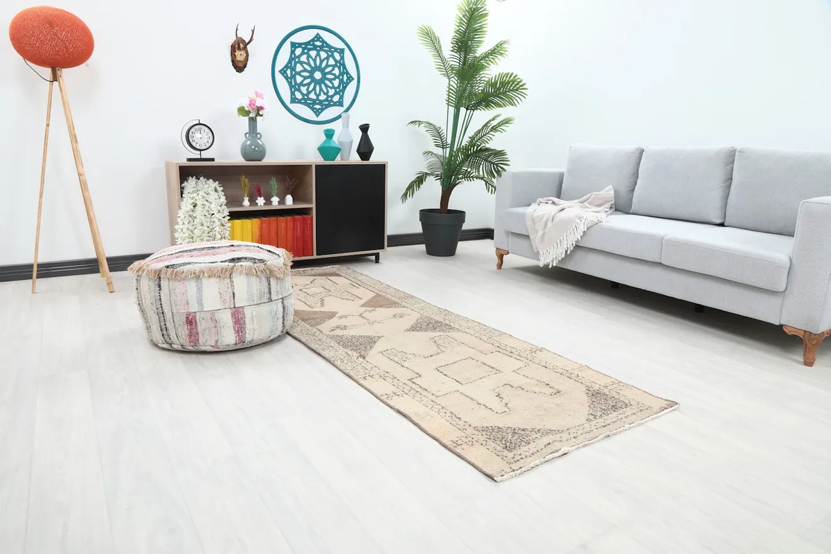 Angled view of the beige and brown runner rug in a modern living space.