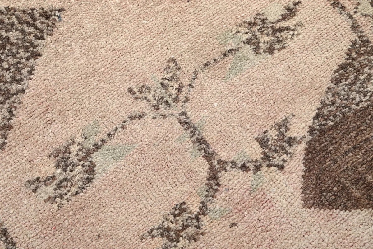 Detailed close-up of a central motif, highlighting the wool pile and subtle olive tones.