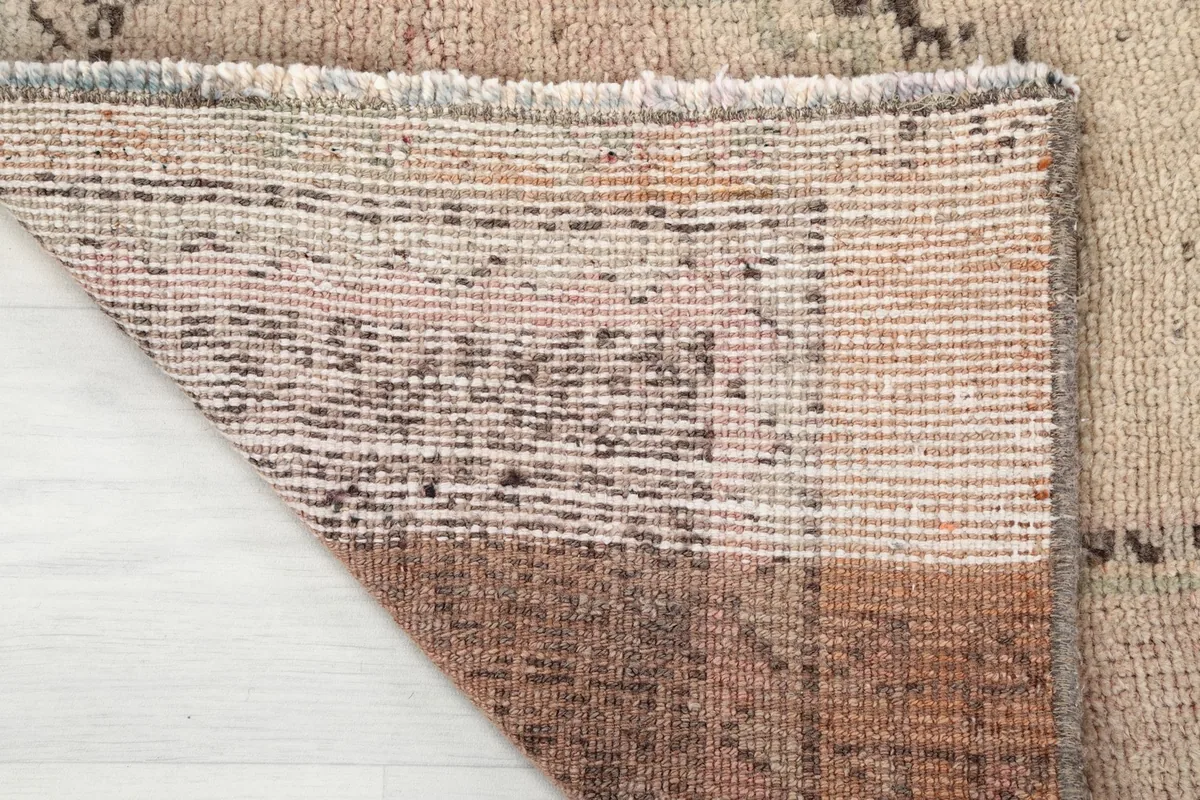 View of the back of the hand-knotted rug, revealing the cotton foundation and knotting.