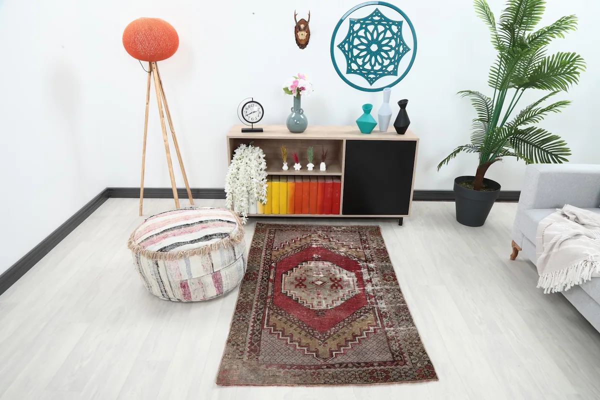 Vintage Red Beige Tribal Medallion rug in a modern living space with a light sofa and colorful books