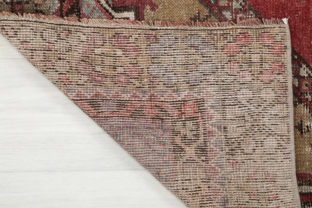 Underside view of the hand-knotted cotton foundation, revealing the rug's construction
