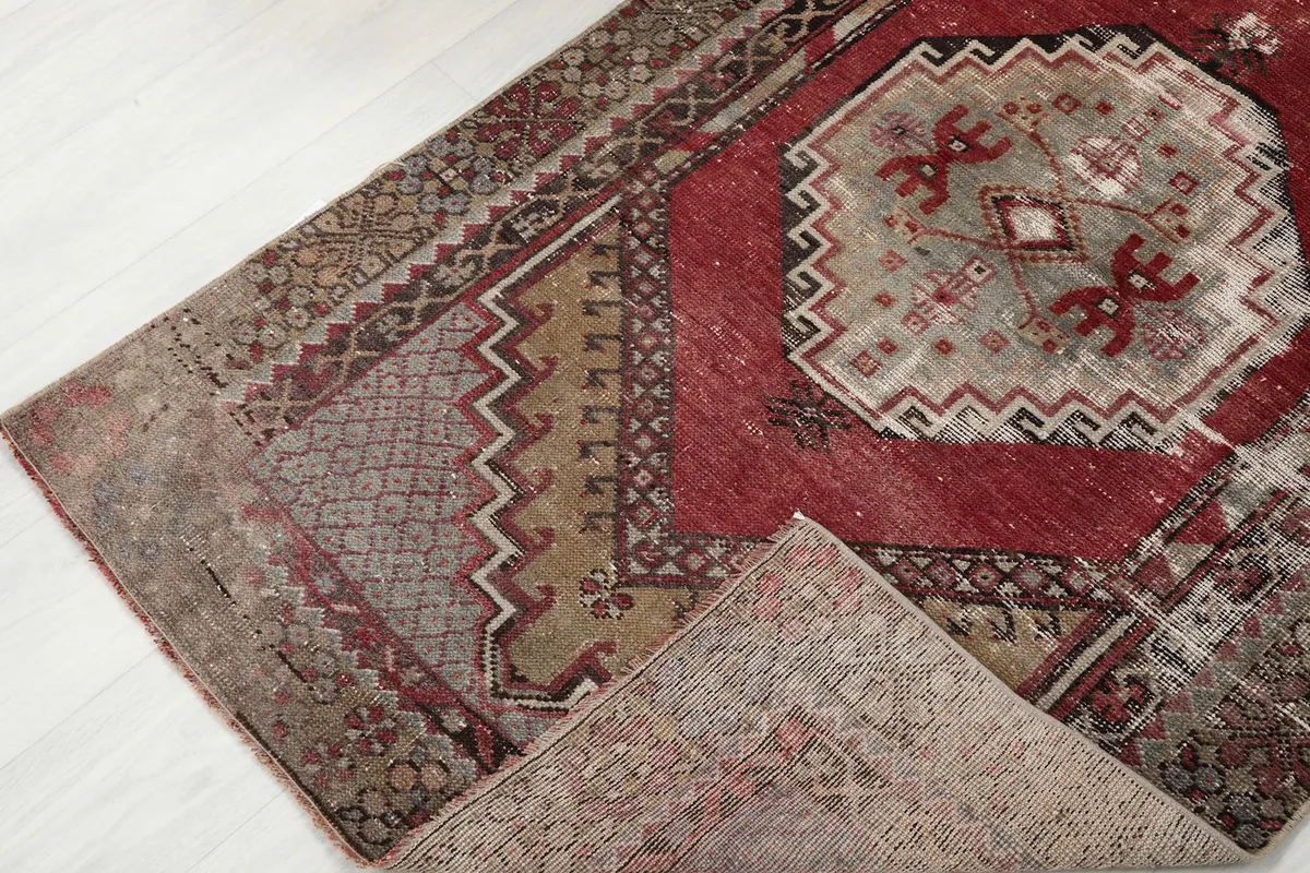 View of the rug folded to show the wool pile texture and the cotton foundation underneath