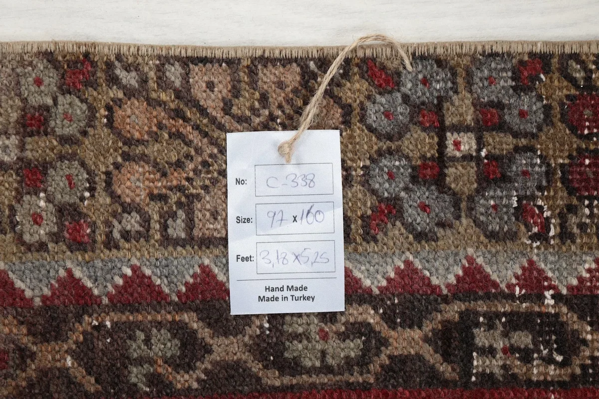 Close-up of the rug's label showing size information and 'Hand Made in Turkey'