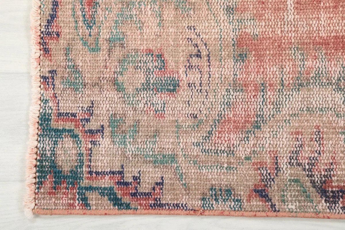 Edge detail showing the border design and the hand-knotted construction of the vintage rug.