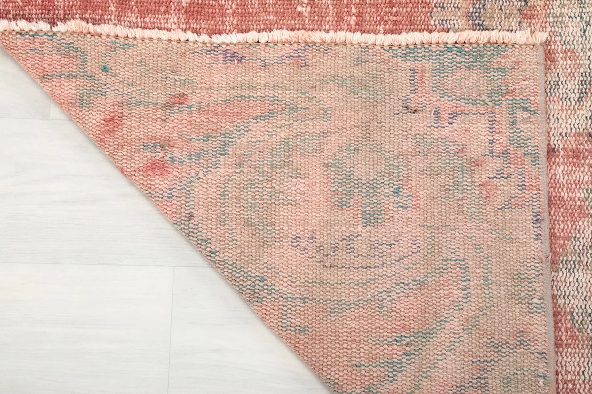 Close-up of the reverse side of the rug, showing the knotting and cotton foundation.