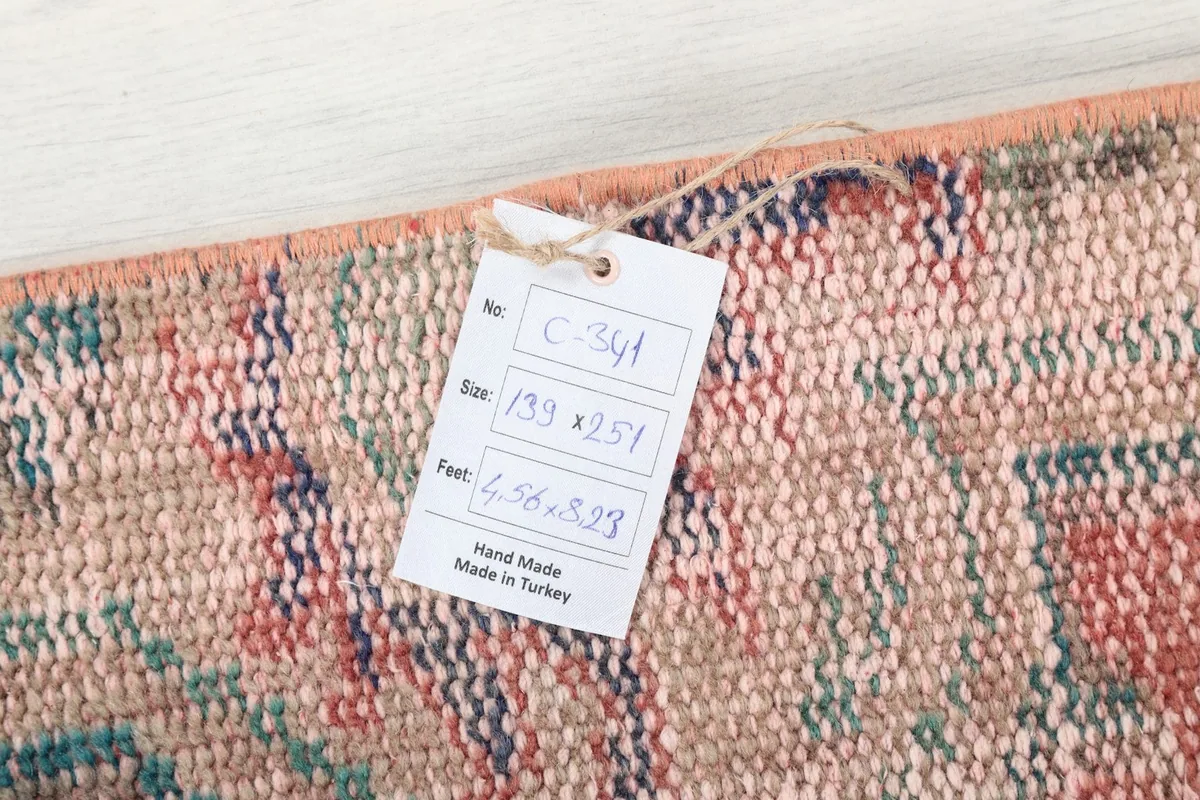 Tag showing the rug's dimensions and origin, confirming it is hand-made in Turkey.