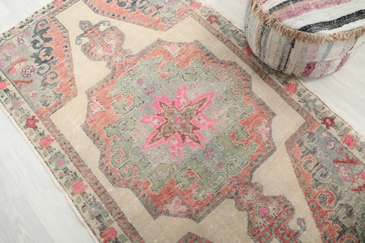 Detailed angle view of the central medallion and surrounding patterns, showcasing the distressed texture.