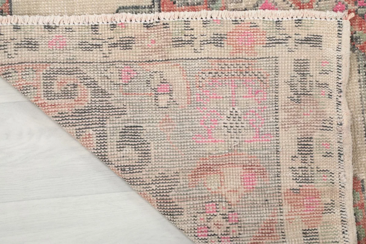 Close-up of the back of the rug, showing the tight knotting on the cotton foundation.