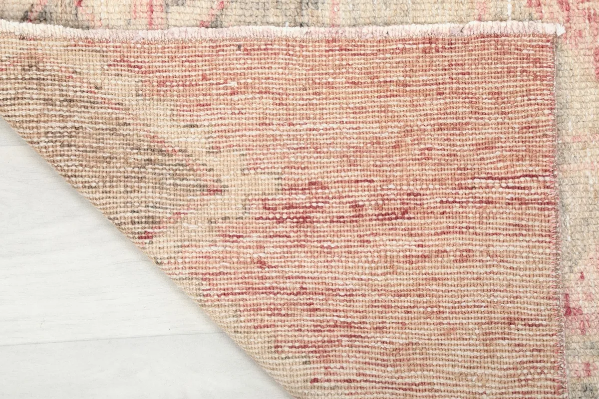 Close-up of the cotton foundation and the reverse side of the hand-knotted wool vintage Anatolian runner.